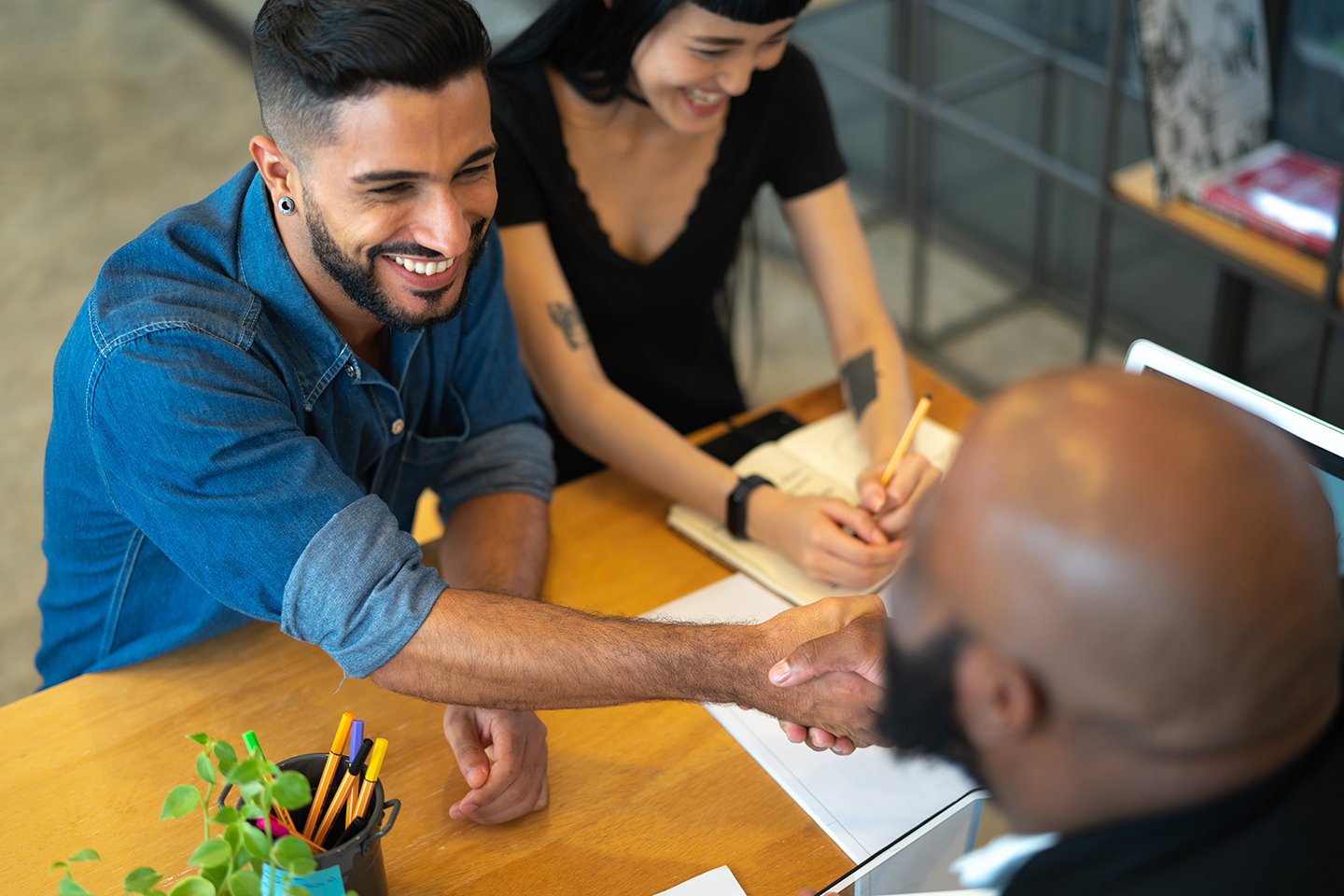 A man shakes hands with a loan agent