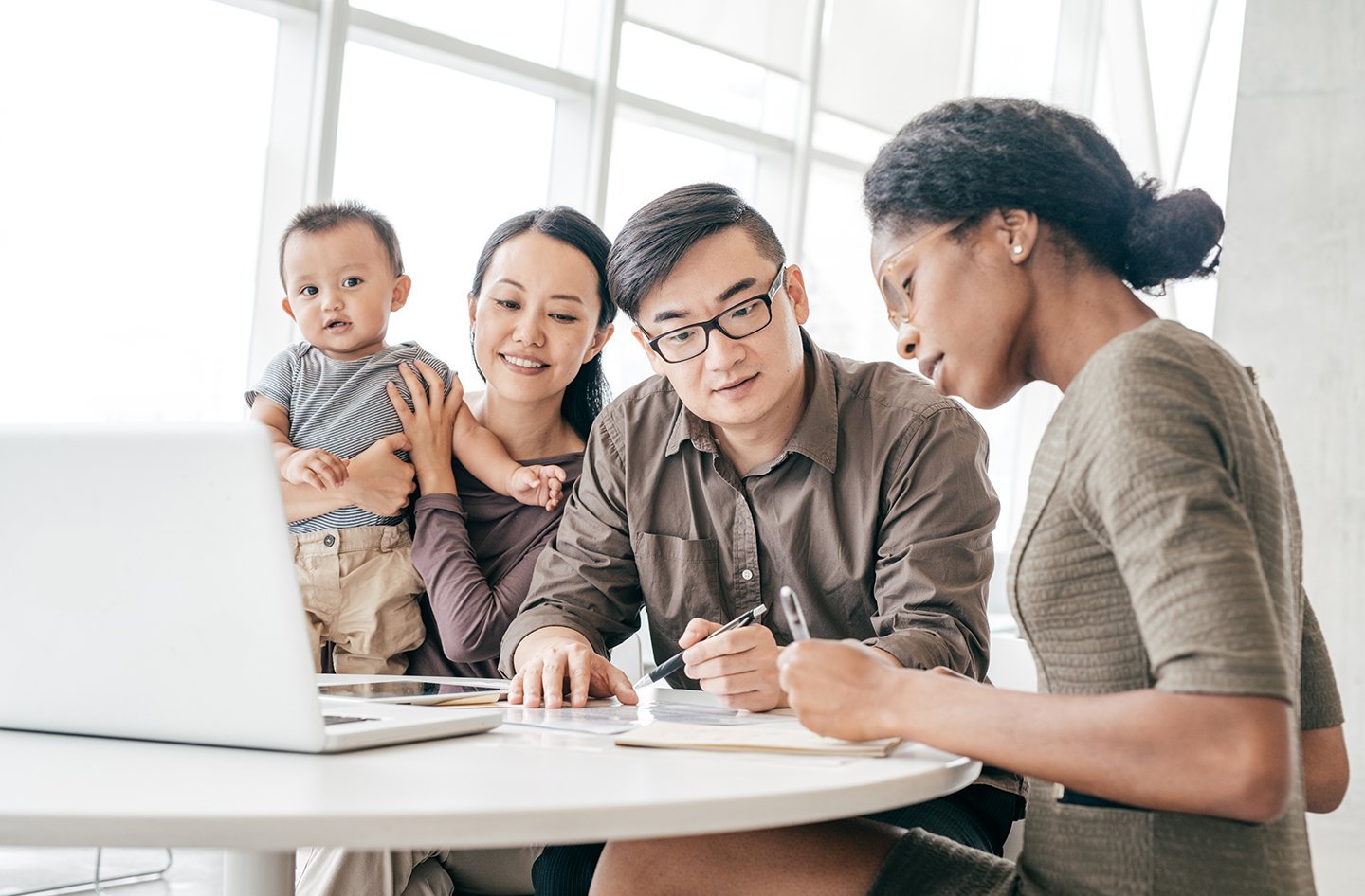 A family with an agent filling out paperwork